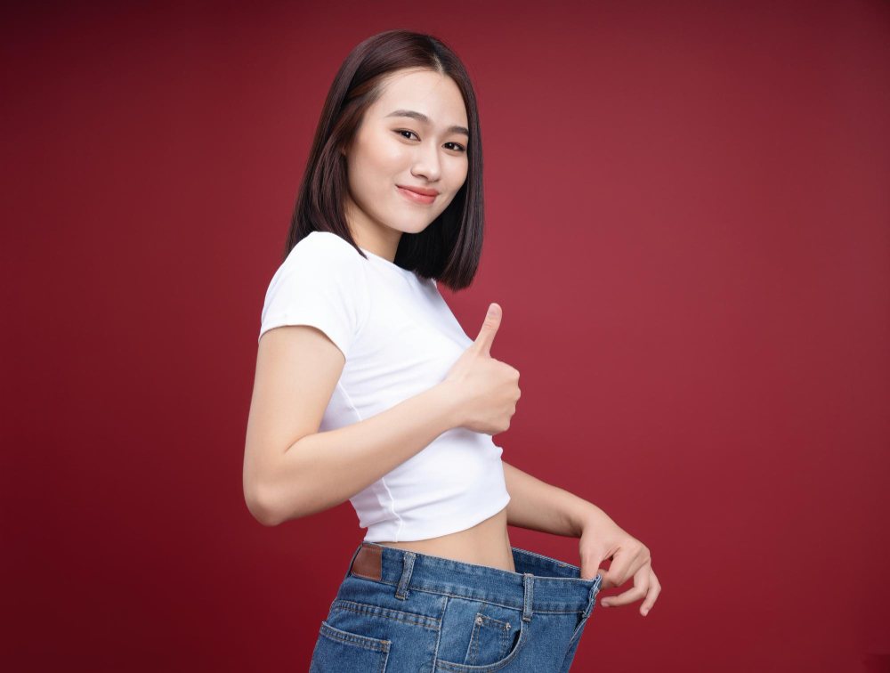 A young woman happy with weight loss